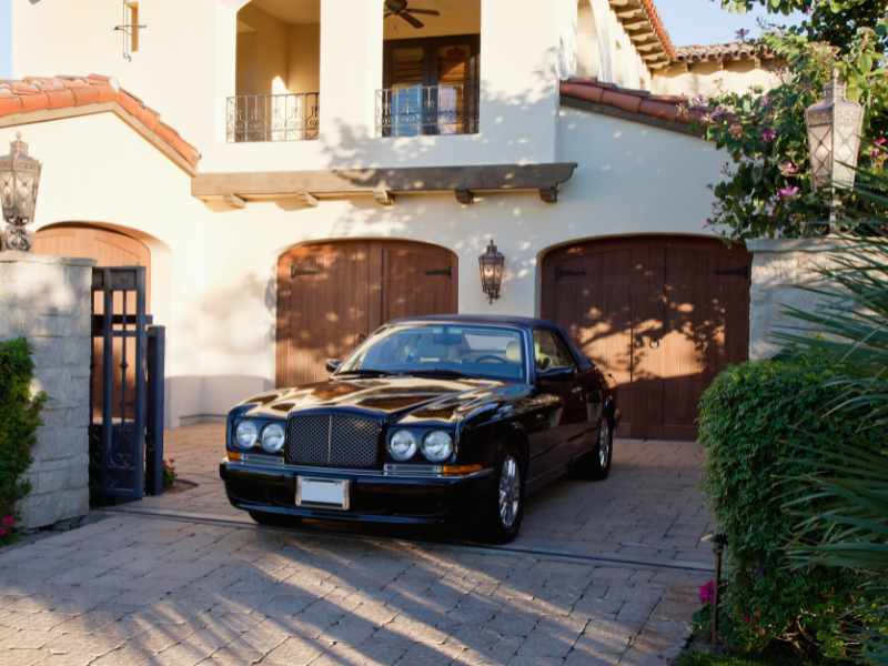 Luxurious car parked in entrance gate of house